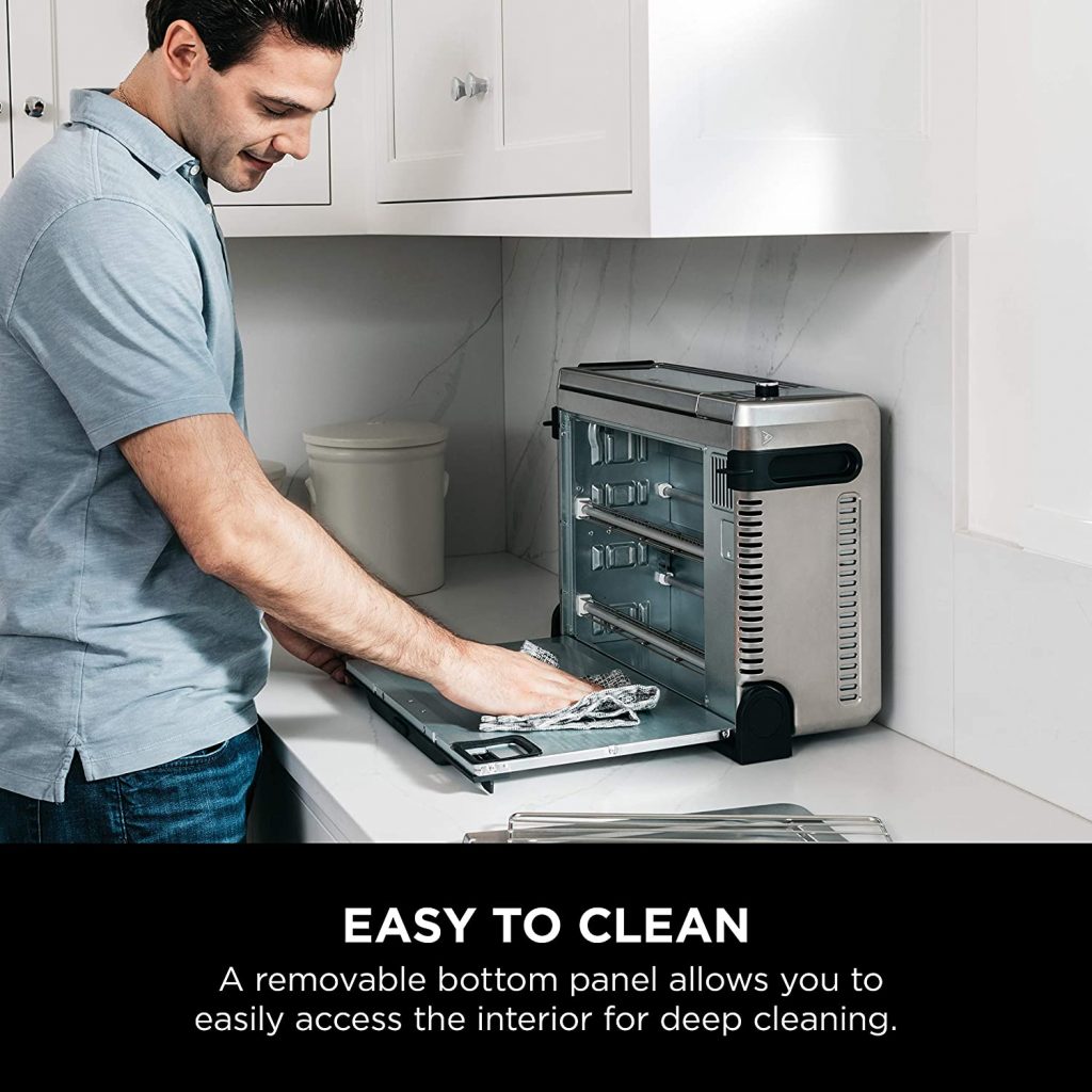 man cleaning oven
